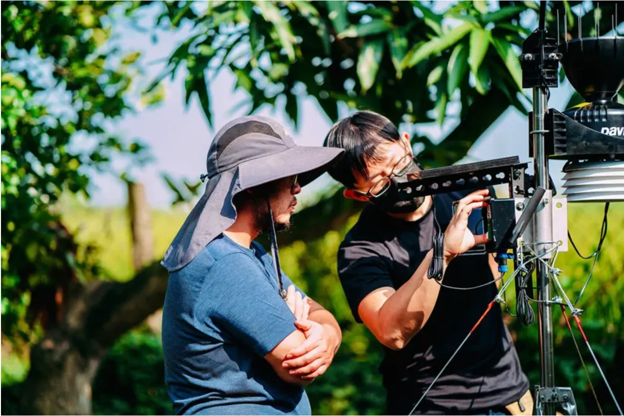 Staff members from Bayer Taiwan and AgriWeather set up sensors at